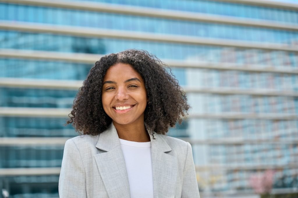 New Business Registration 3 Happy young African American business woman on street, headshot portrait.