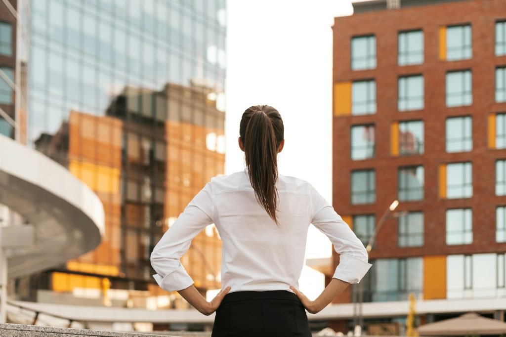 New Business Registration 5 Rear view of businesswoman looking business buildings